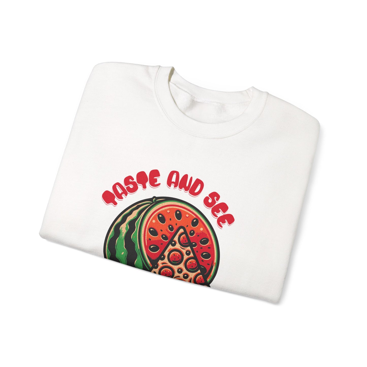 Folded white sweatshirt with 'Taste and See the Lord is Good' Bible verse and colorful food graphic. Comfortable Christian gift idea.