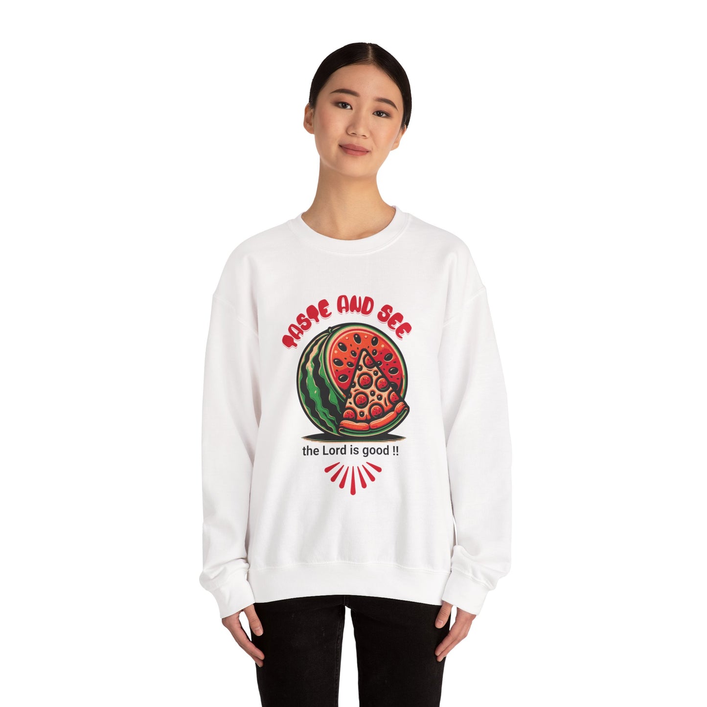 Model wearing white inspirational crewneck sweatshirt with 'Taste and See the Lord is Good' message and vibrant food design. Cozy religious apparel.