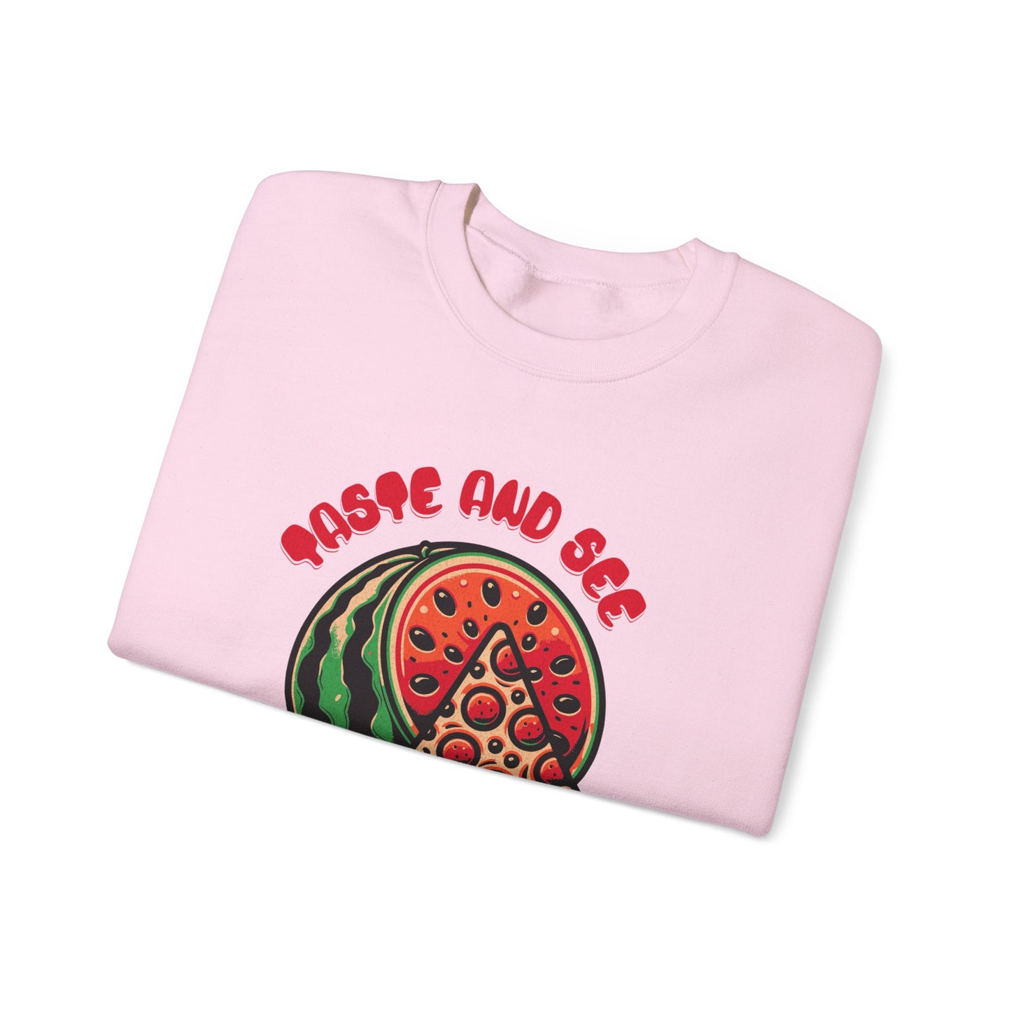 Folded pink sweatshirt with 'Taste and See the Lord is Good' scripture quote and colorful food design. Ideal for Christian fashion lovers.