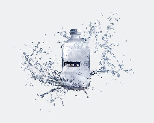 a bottle of water with water splashing around it