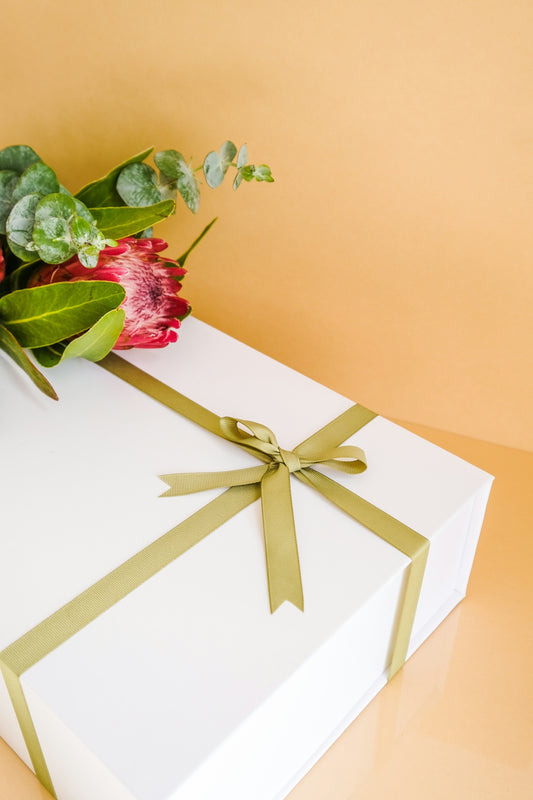 a rose on a white shelf