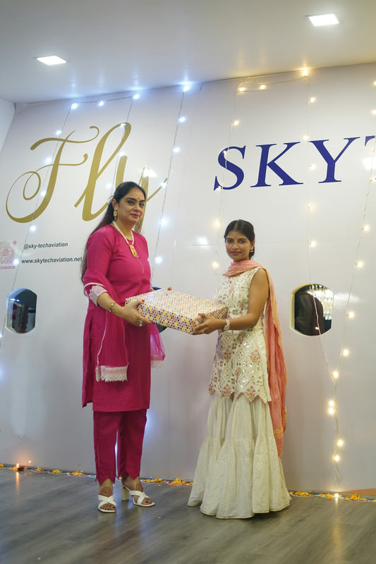 Two women receiving a gift in a decorated room