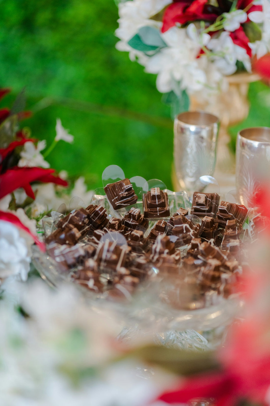 A pile of decorative chocolates on a glass plate.