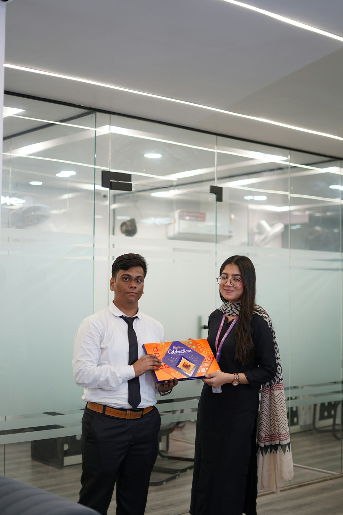 Man and woman holding a gift box