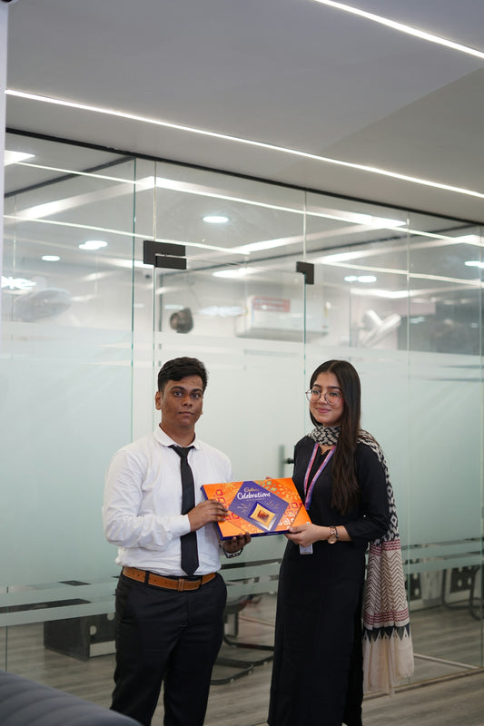 Man and woman holding a gift box