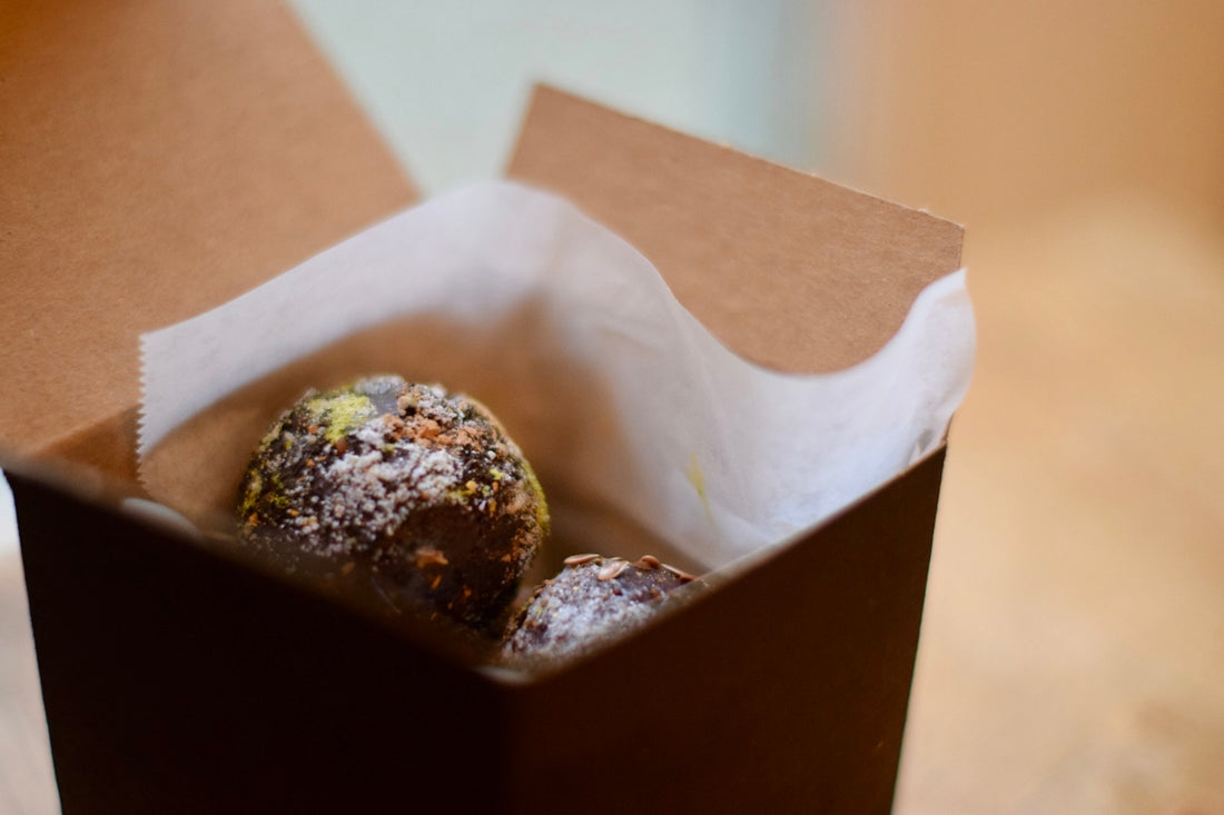 Two chocolate truffles in a small box
