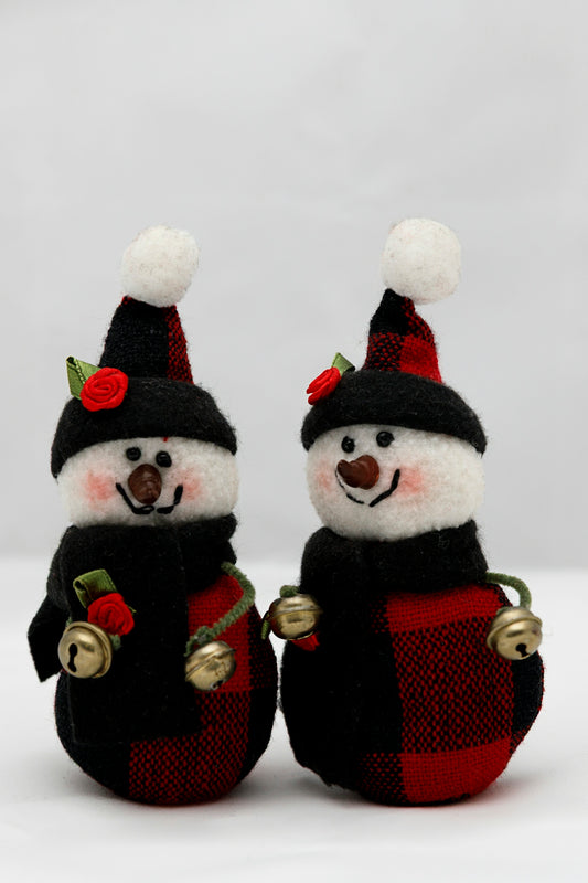 Two cute snowman decorations with red plaid scarves.