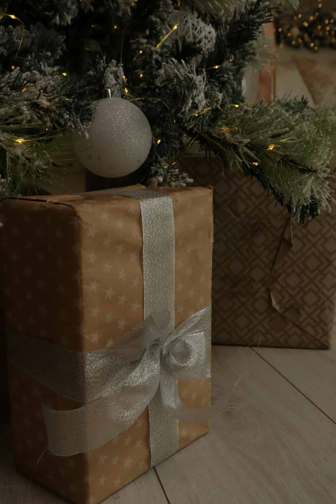 Wrapped gifts under a decorated christmas tree.