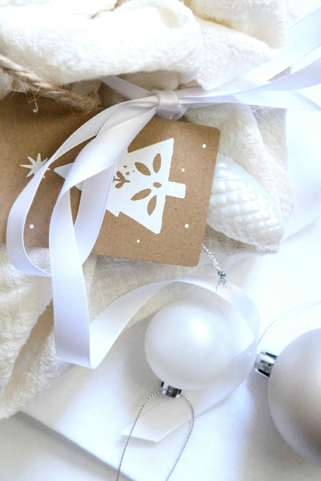 Wrapped gift with christmas tree tag and ornaments