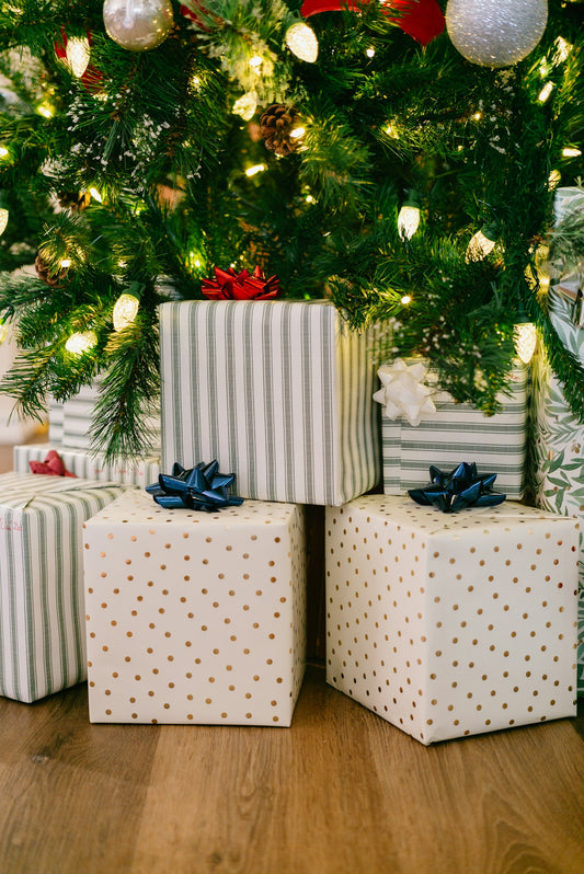 Wrapped gifts under a decorated christmas tree.