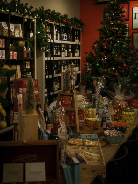 A store decorated for christmas with a tree and gifts.