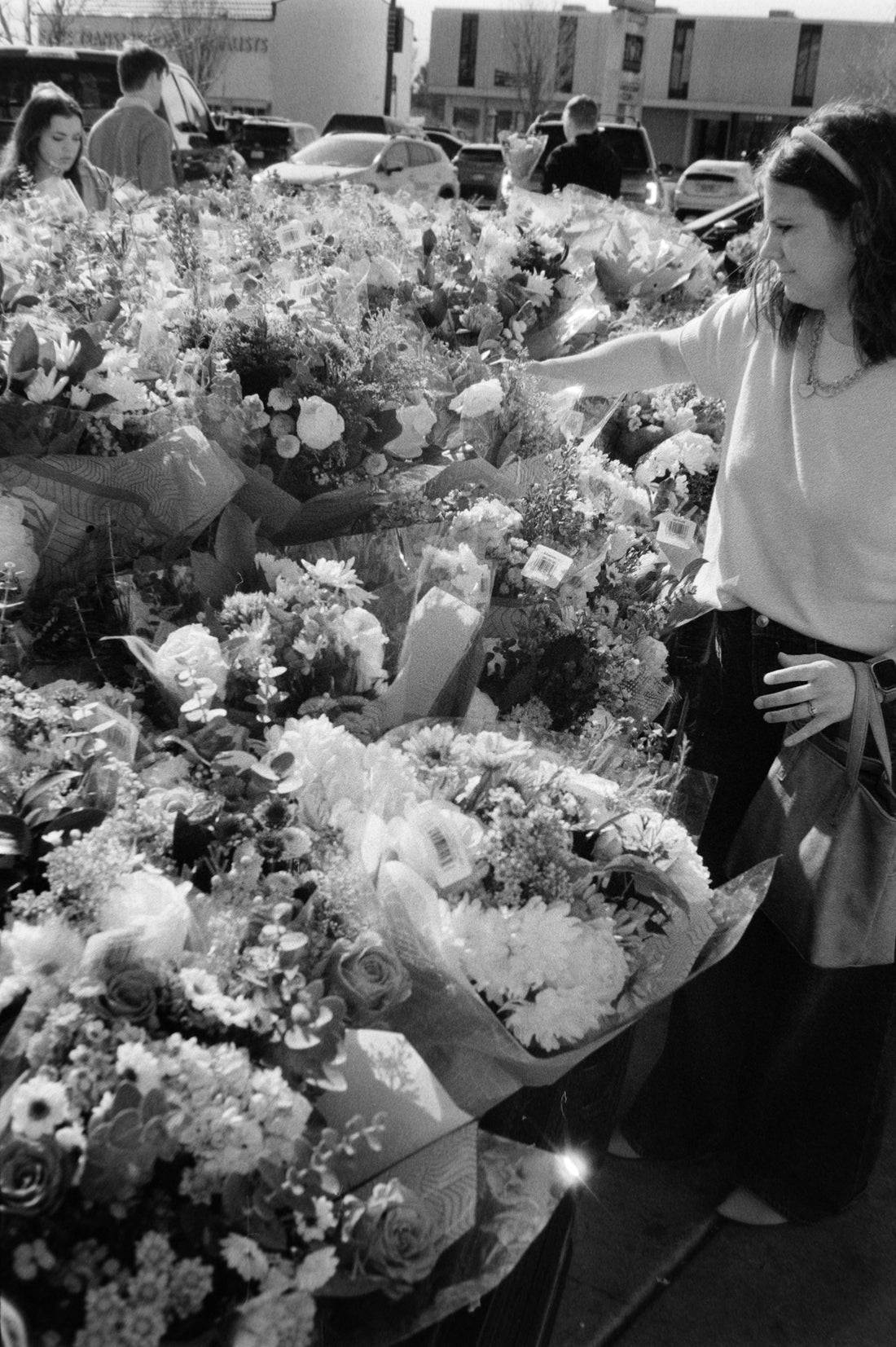 Woman browsing a large display of flowers