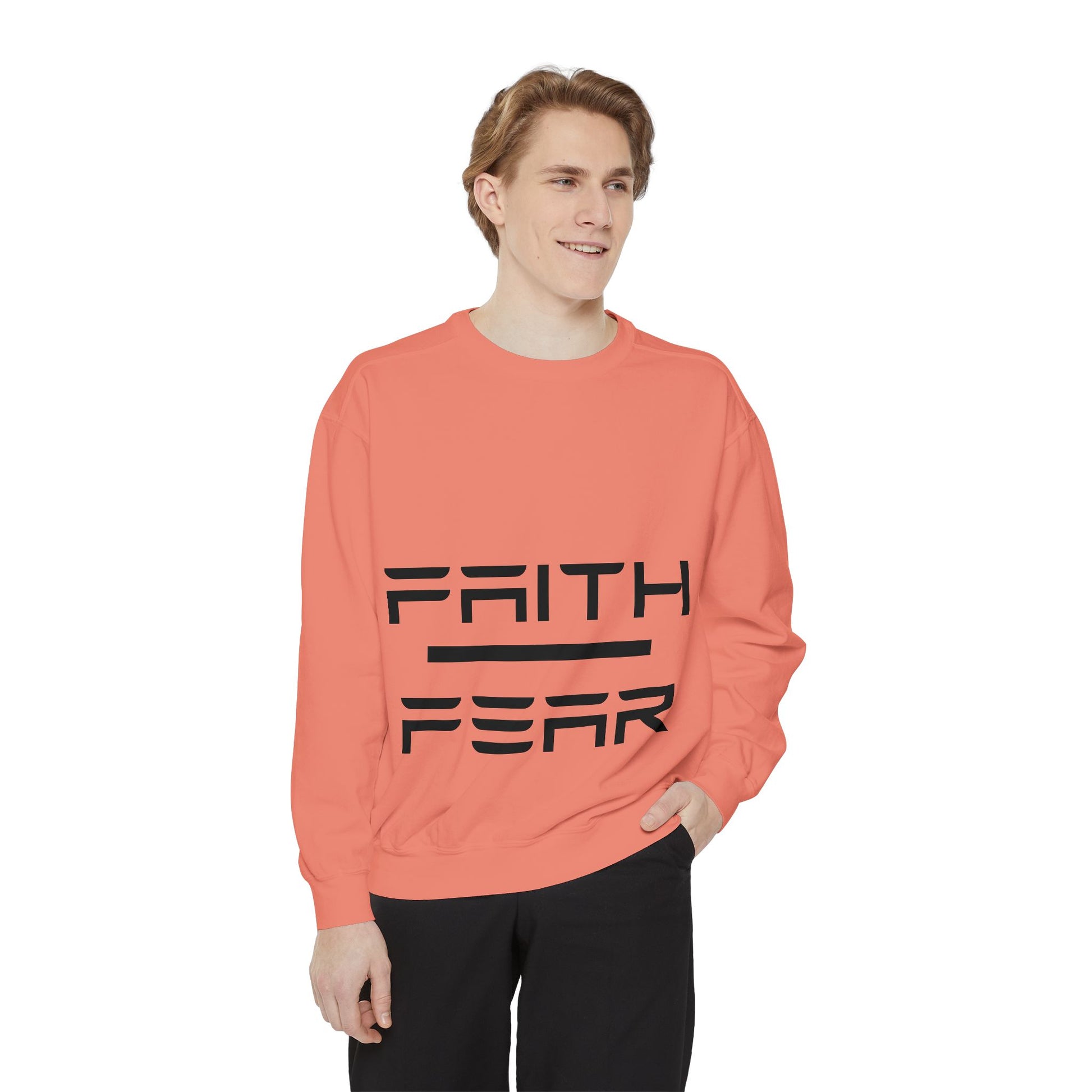 Model wearing coral Faith Over Fear sweatshirt, featuring bold black text for a motivational and stylish casual outfit.
