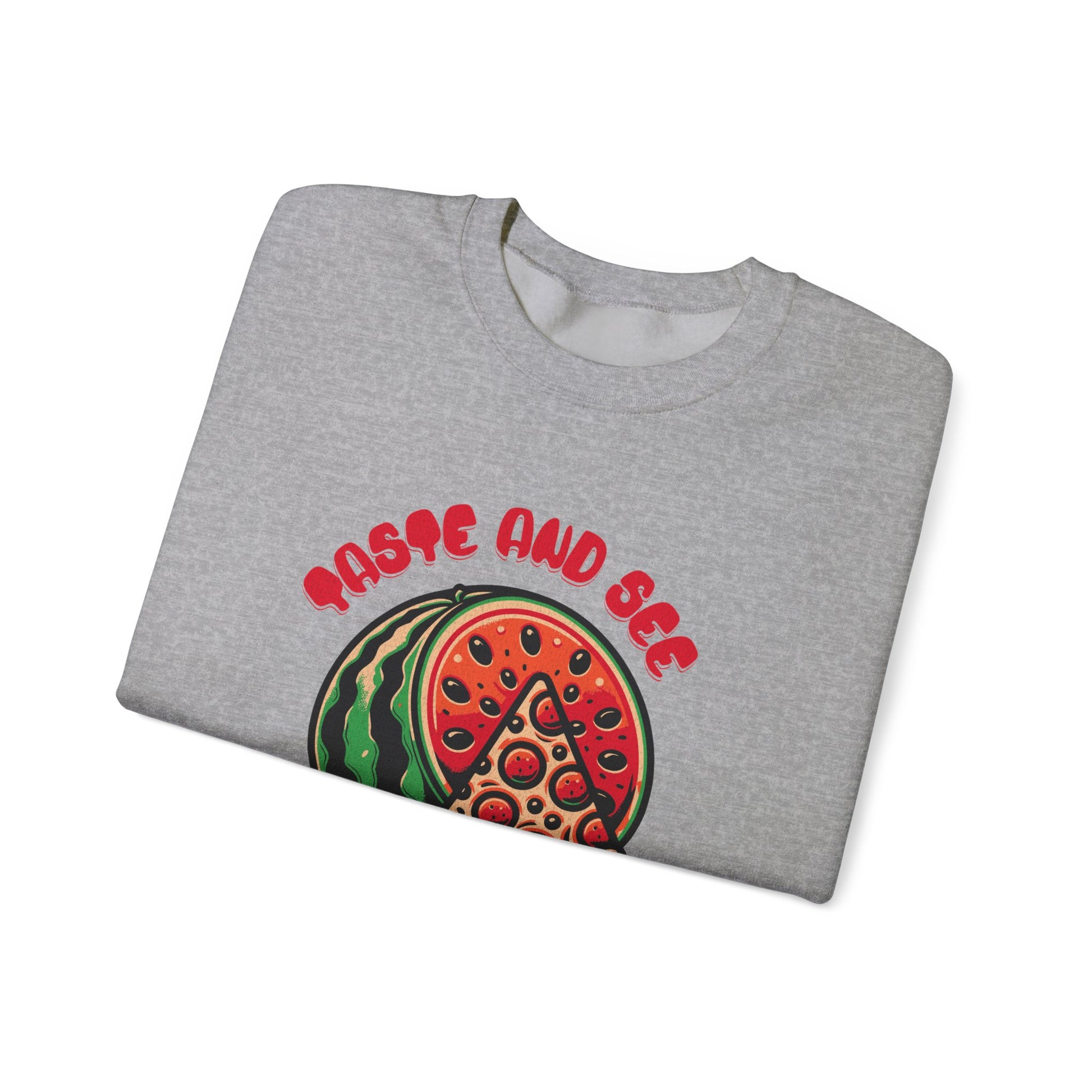 Folded gray sweatshirt featuring 'Taste and See the Lord is Good' inspirational message with pizza and watermelon graphic. Spiritual fashion staple.