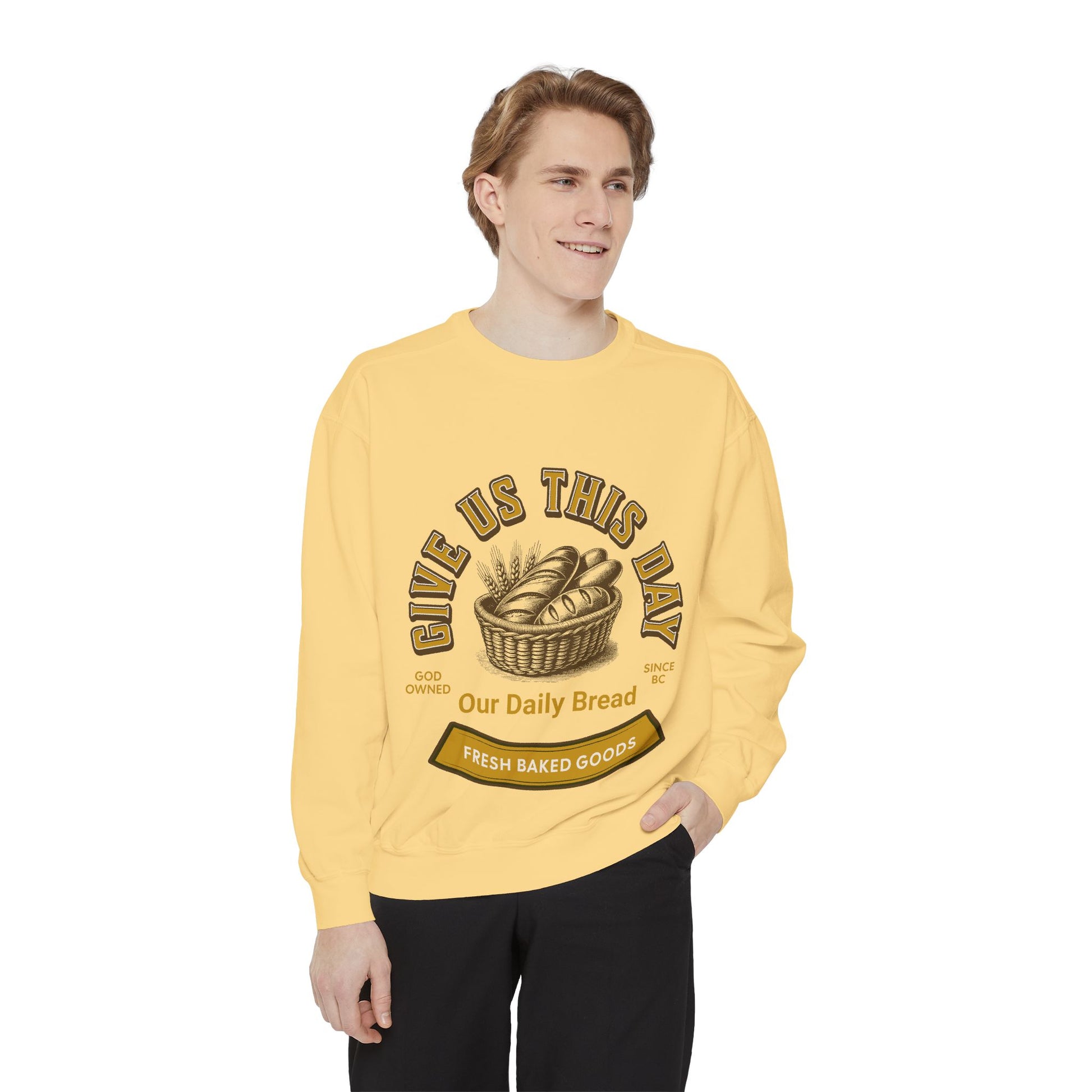 Model in yellow Inspirational Crewneck Sweatshirt featuring 'Give us this Day Our Daily Bread' and bread basket. Faith-inspired unisex fashion.